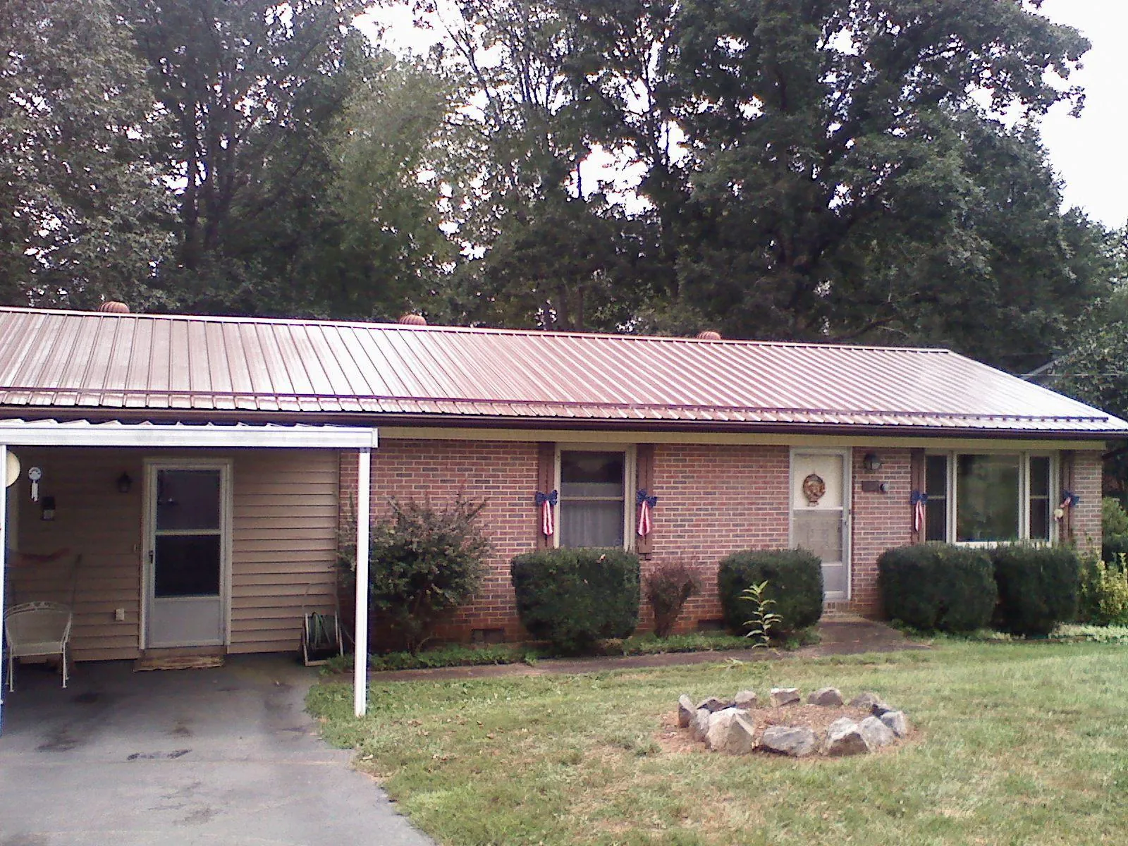 Bronze metal roof and carport on a brick ranch home — Roof Repair work by our crew in Schaumburg